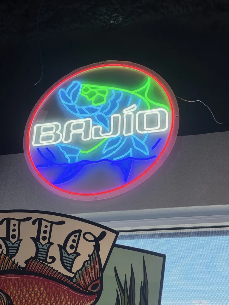 Colorful neon fishing sign inside the tackle shop