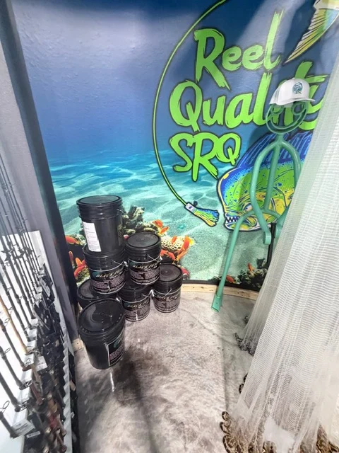 Reel Quality SRQ window artwork beside a shop display