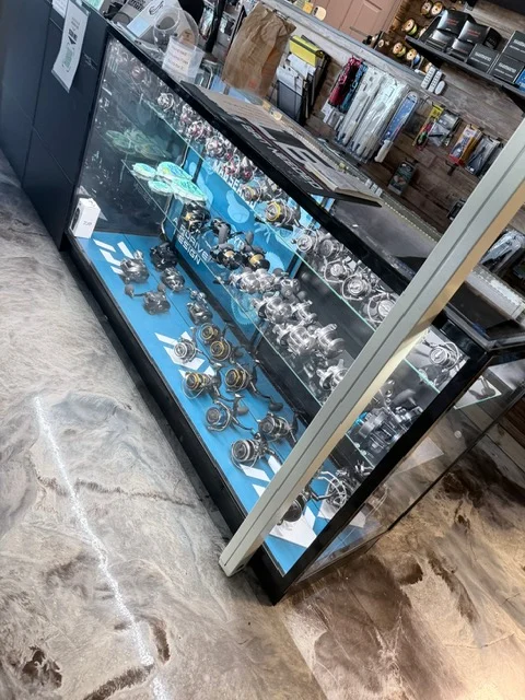 Glass display counter with fishing reels