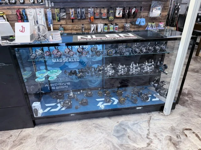 Fishing reels in a glass shop display case