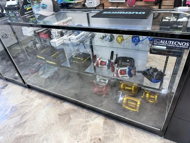 Glass counter displaying large fishing reels