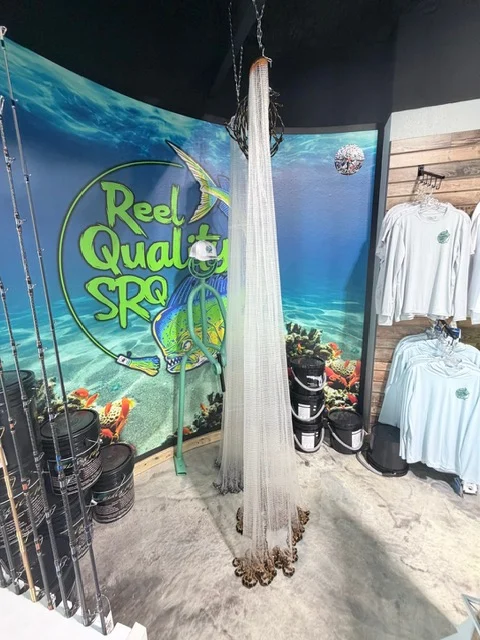 Window artwork and fishing rods near the storefront