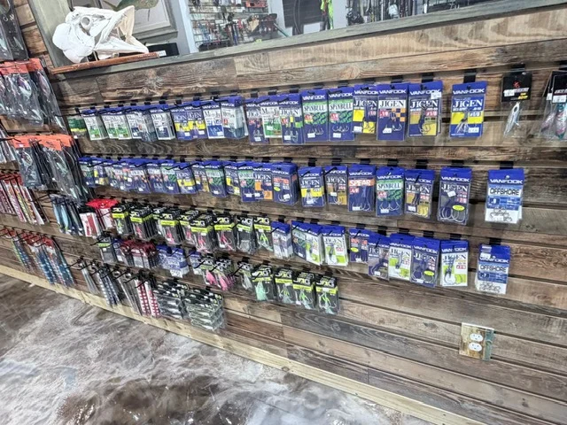 Packaged fishing accessories on a long retail wall
