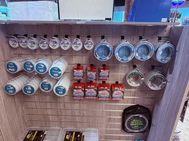 Fishing line spools and maintenance products on a wall