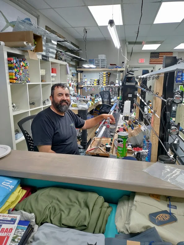 Staff member behind a shop counter