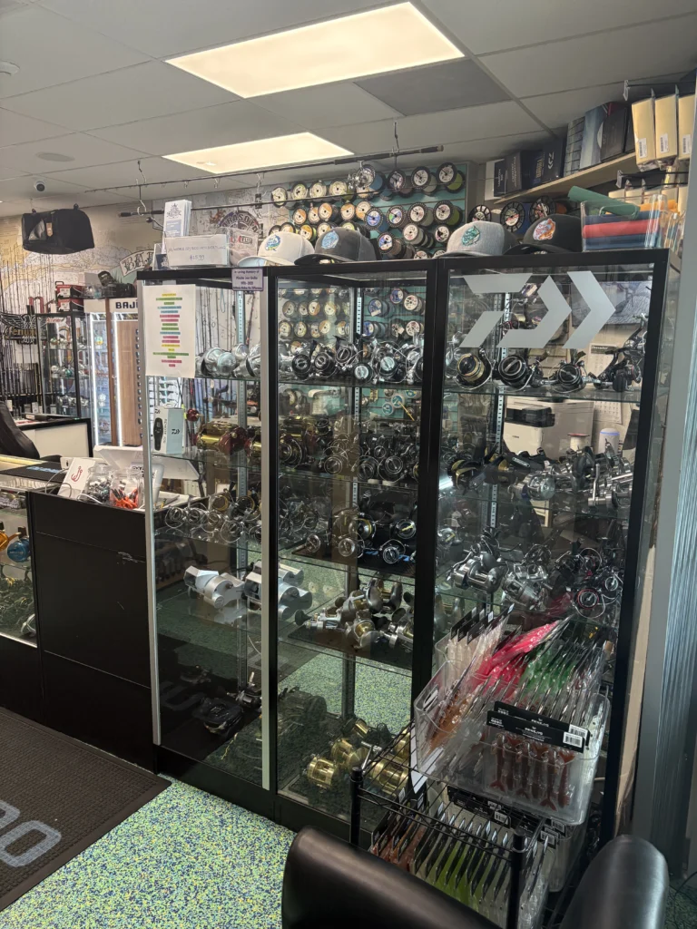 Fishing reels displayed in a glass cabinet