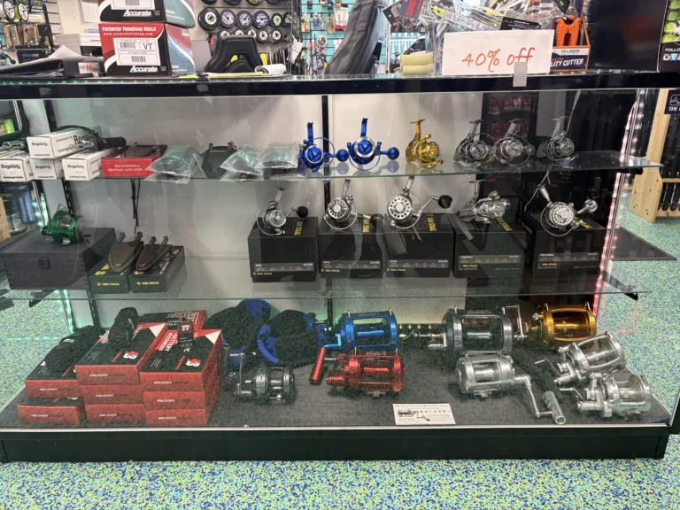 Fishing reels and accessories arranged in a glass case